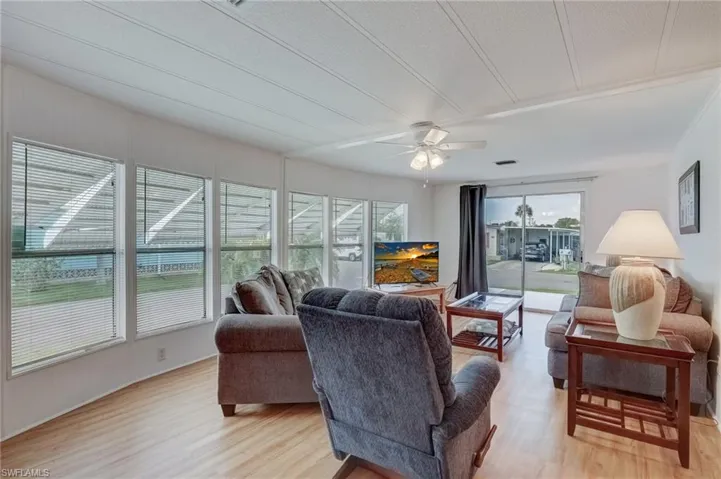 Living area featuring light wood-type flooring and a ceiling fan