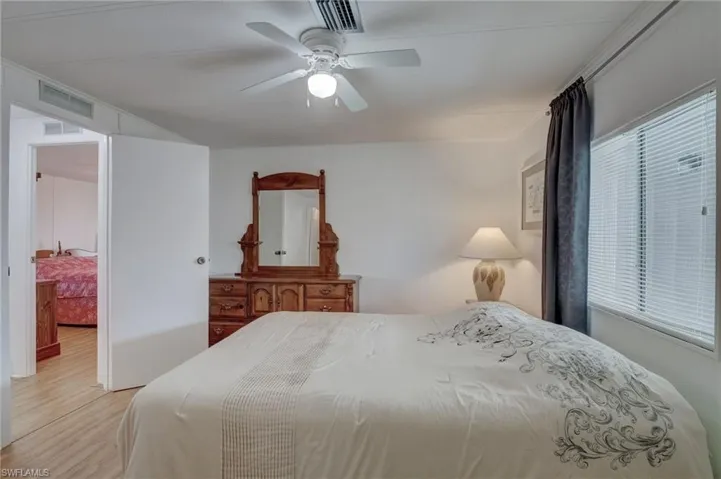 Bedroom with a ceiling fan and wood finished floors