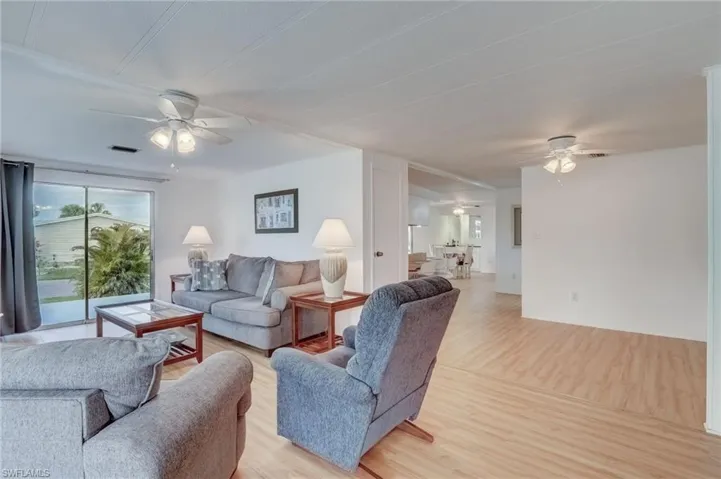 Living room with a ceiling fan and wood finished floors