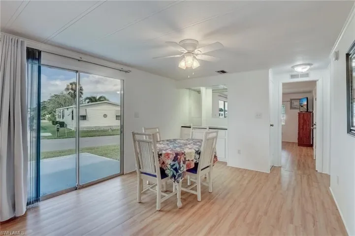 Dining space with healthy amount of natural light, light wood finished floors, and a ceiling fan