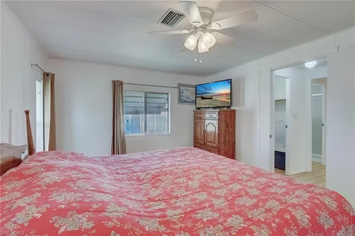 Bedroom with a ceiling fan and crown molding