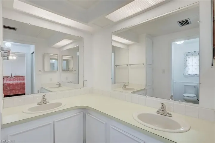 Ensuite bathroom featuring toilet and double vanity