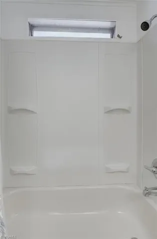 Bathroom featuring shower / bath combo with shower curtain