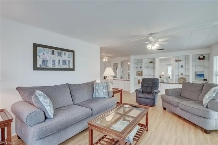 Living area featuring light wood-style floors and ceiling fan