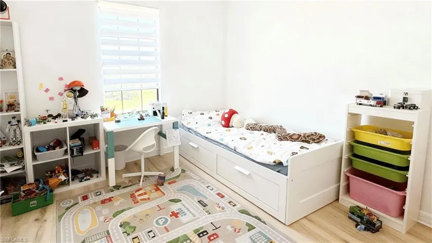 Bedroom with light wood-style floors