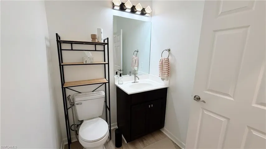 Half bath with vanity and toilet