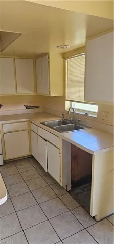 Kitchen featuring light countertops, light tile patterned floors, and cream cabinetry