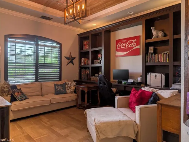 Den featuring built in book shelves