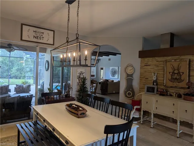 Tiled dining area with slider doors to pool