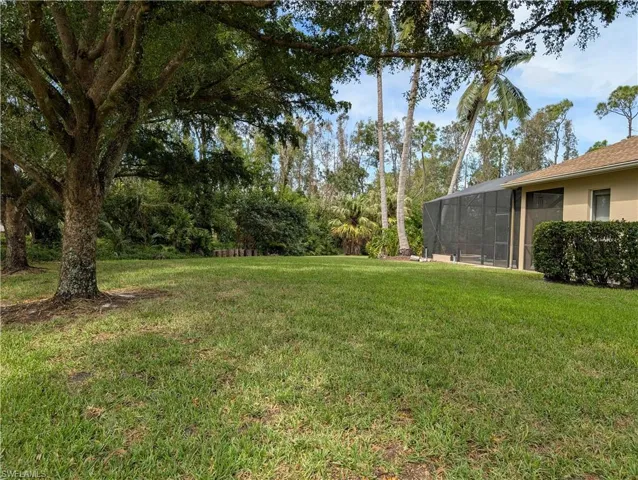 Right-side view of house with beautiful oak trees lining the yard
