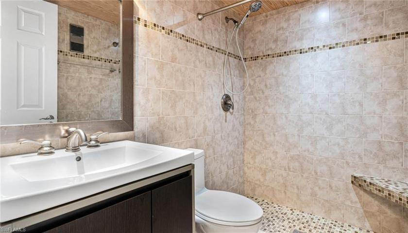 Fabulous shower stool with tastefully accented tiles throughout