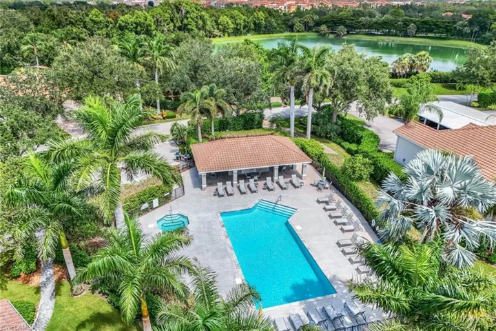Community pool with a water view and a patio area