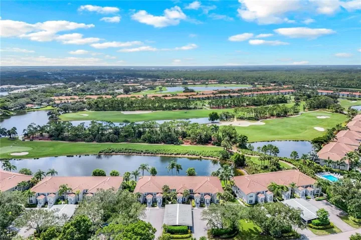 Aerial view of residential area with a golf course and a large body of water