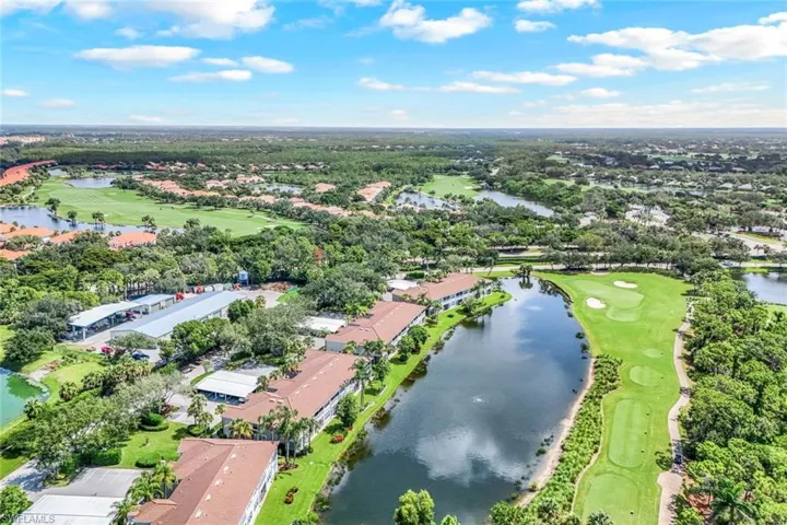 View of property location featuring a golf course and nearby suburban area