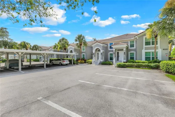 Partially covered parking lot featuring a residential view