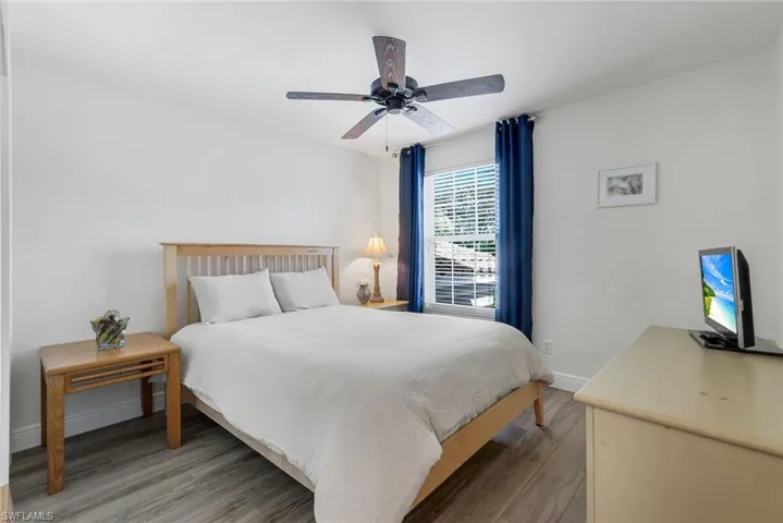 Bedroom with light wood-style floors and ceiling fan
