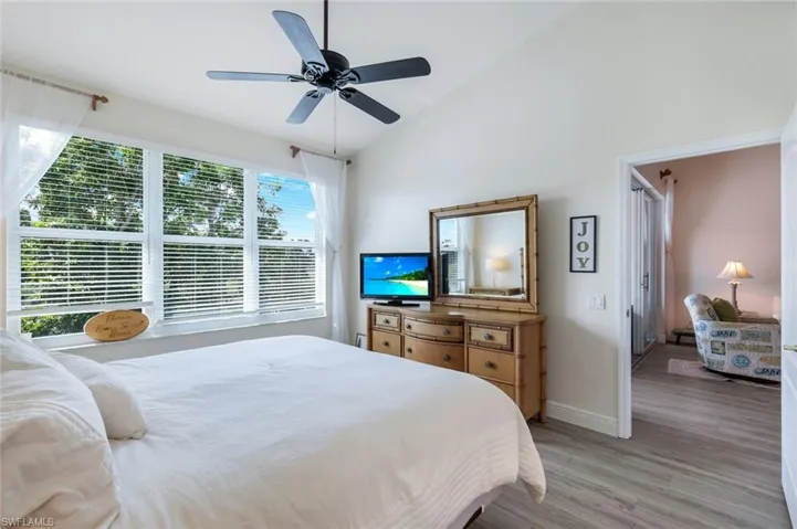 Bedroom featuring lofted ceiling, light wood-style floors, and ceiling fan