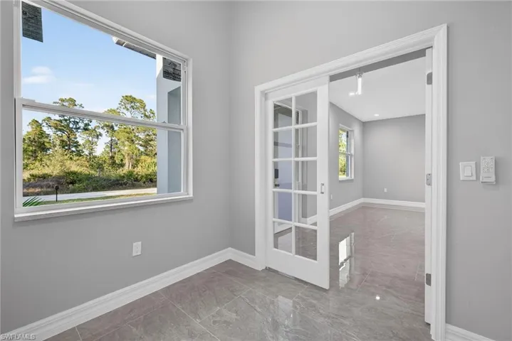 Empty room featuring baseboards
