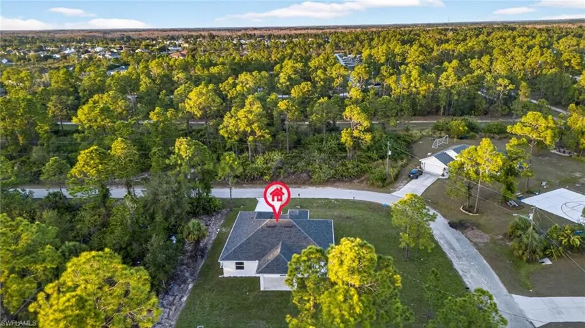 View of property location featuring a forest