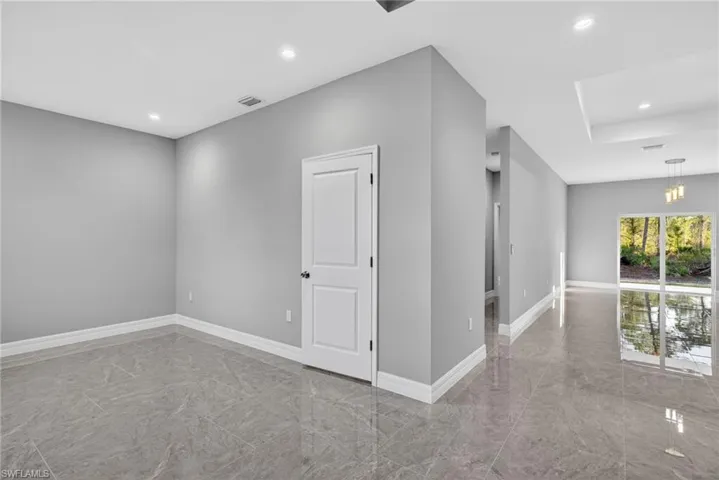 Empty room with recessed lighting and light marble finish flooring
