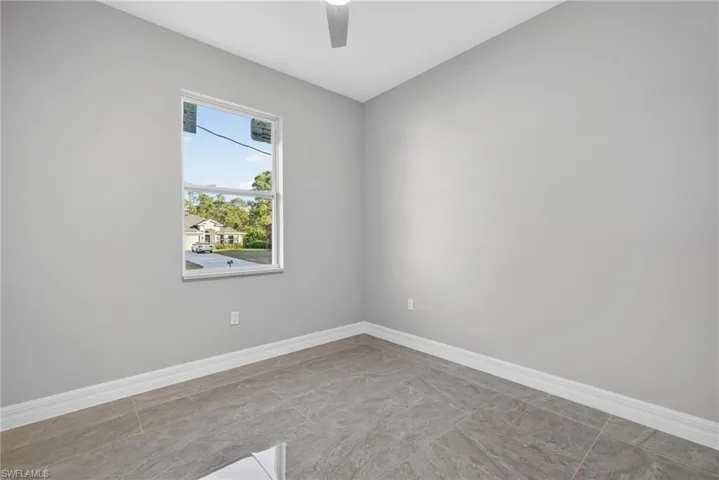 Unfurnished room with baseboards