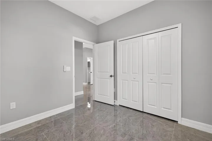 Unfurnished bedroom featuring baseboards and a closet