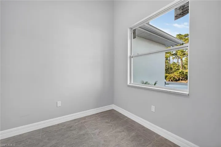 Empty room featuring baseboards