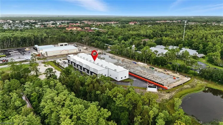 Drone / aerial view of a heavily wooded area and a large body of water