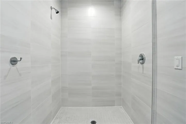 Full bath with a tile shower