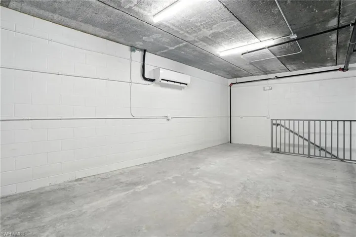 Garage with concrete block wall and a wall unit AC