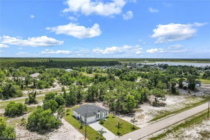 Aerial view of a nearby body of water and a heavily wooded area