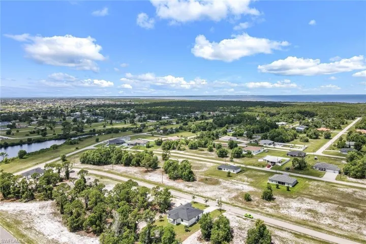 Aerial view of residential area featuring a nearby body of water