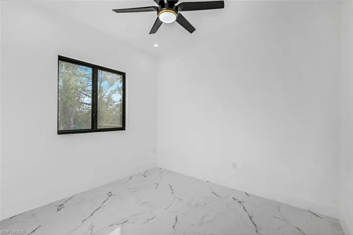 Unfurnished room with light marble finish flooring, a ceiling fan, and recessed lighting