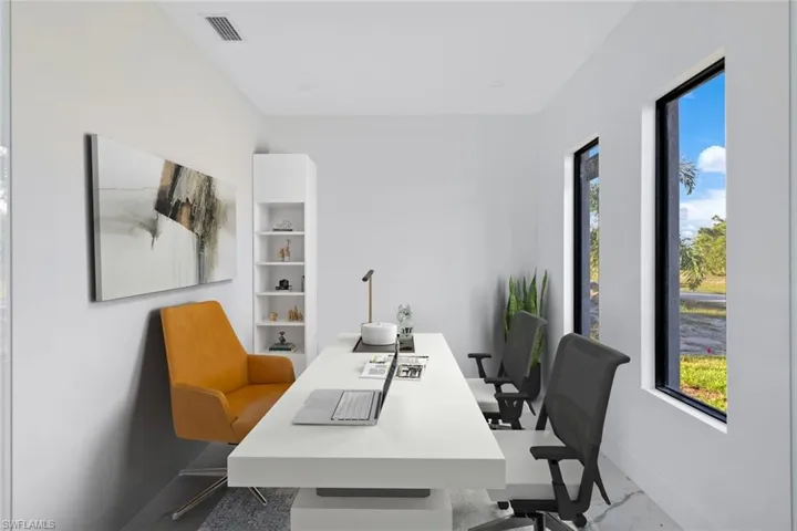 Office featuring healthy amount of natural light and marble finish flooring
