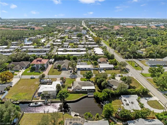 Aerial view of property's location with nearby suburban area and a large body of water