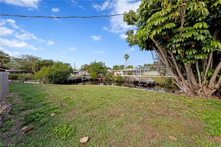 View of grassy yard with a water view