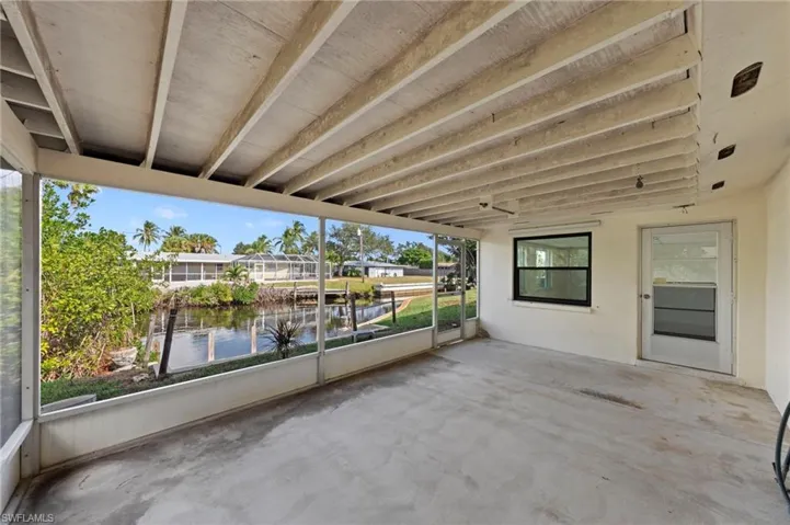 View of patio with a water view and a sunroom