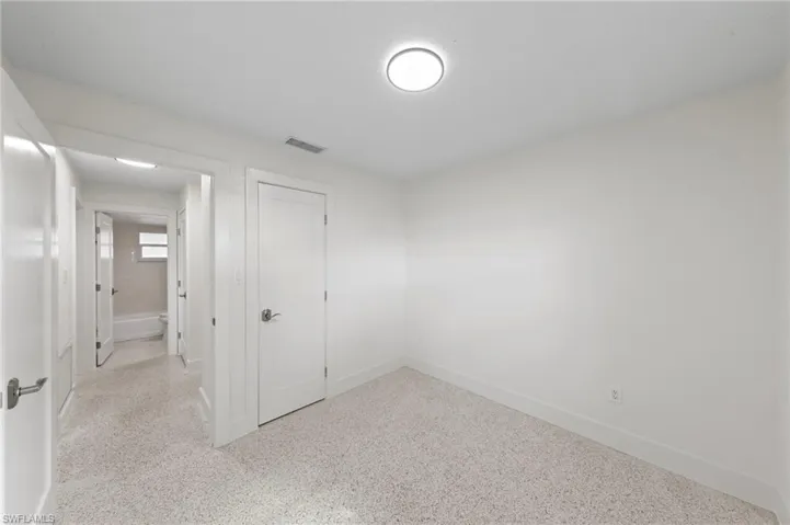 bedroom with a closet and dark speckled floor