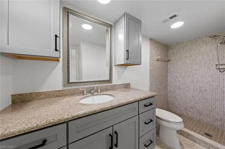 Bathroom featuring vanity, a stall shower, and recessed lighting