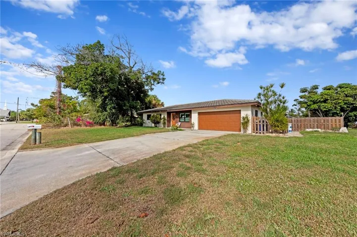 Ranch-style home featuring concrete driveway, stucco siding, and an attached garage
