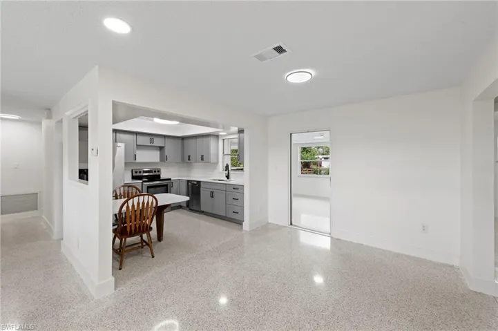 Kitchen with gray cabinetry, light countertops, stainless steel electric stove, black dishwasher, and recessed lighting