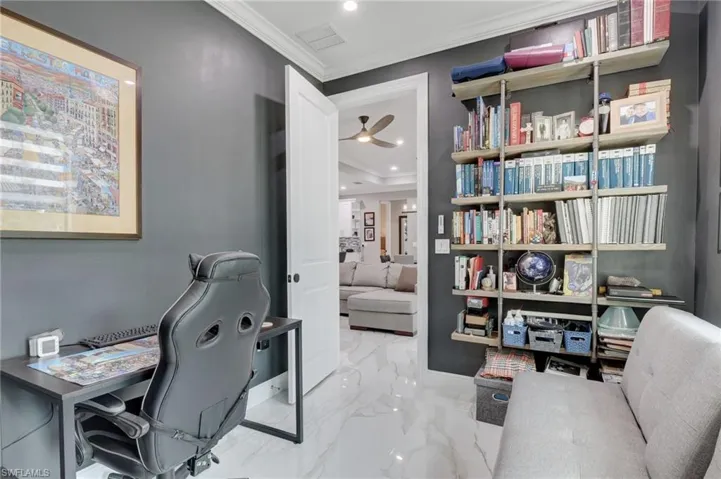 Tiled office with ornamental molding and ceiling fan