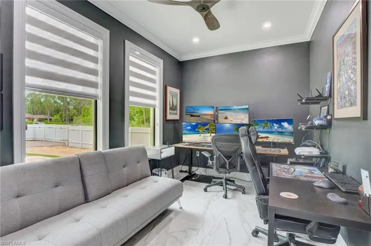 Tiled office space featuring ornamental molding and ceiling fan