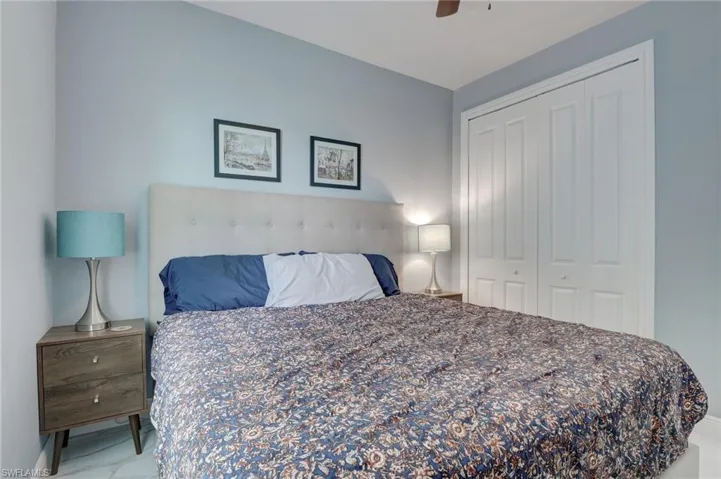 Tiled bedroom featuring a closet and ceiling fan