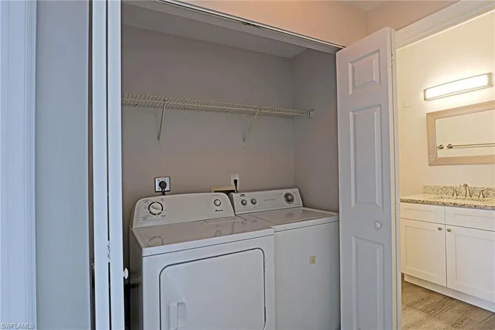 Laundry area featuring washer and clothes dryer and light wood-style flooring