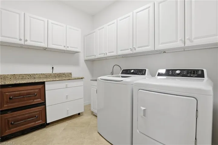 Laundry room featuring cabinet space and separate washer and dryer