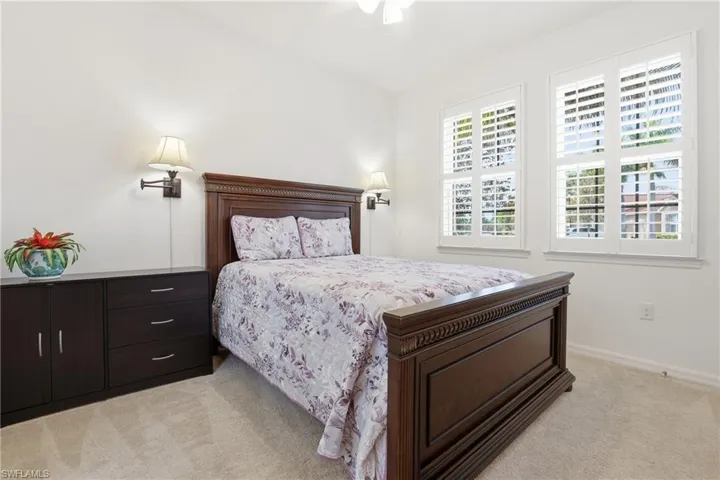 Bedroom featuring light colored carpet and ceiling fan