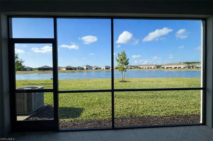 Unfurnished sunroom with a residential view and a water view