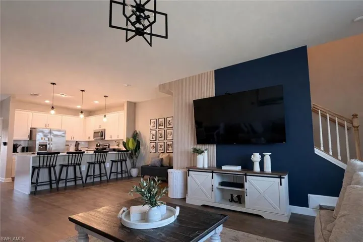 Living area featuring dark wood-style floors and recessed lighting
