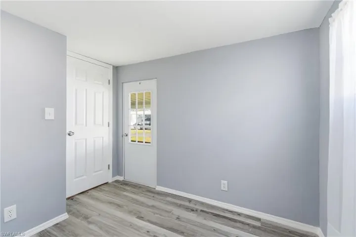 Unfurnished bedroom with light wood-style flooring and baseboards